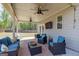 Inviting covered patio with stylish seating and outdoor living space at 7435 Ansley Park Way, Cumming, GA 30028
