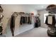 Walk-in closet providing ample storage with shelving and hanging rods, complete with carpeted floors at 7435 Ansley Park Way, Cumming, GA 30028