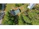 Overhead view of home and yard with mature trees, a lush lawn, and a paved driveway and road at 1256 Horsley Mill Rd, Carrollton, GA 30116