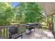 Wooden deck featuring furniture, a grill, and lots of trees in the background at 1256 Horsley Mill Rd, Carrollton, GA 30116