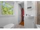 Bathroom featuring a window, modern vanity and toilet at 1256 Horsley Mill Rd, Carrollton, GA 30116