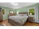 Spacious bedroom featuring a large bed, wood floors, and natural light from a window at 1256 Horsley Mill Rd, Carrollton, GA 30116