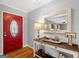 Inviting entryway featuring a red door, a stylish console table, and a decorative mirror, setting a welcoming tone at 1256 Horsley Mill Rd, Carrollton, GA 30116