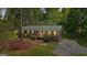Attractive single-story house with a green metal roof, gray siding, and a lovely lawn with mature trees at 1256 Horsley Mill Rd, Carrollton, GA 30116