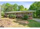Charming single-story home with a wooden porch, gray siding, and a well-manicured lawn at 1256 Horsley Mill Rd, Carrollton, GA 30116