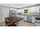 Bright kitchen features white cabinets, granite countertops, stainless steel appliances, and a spacious island at 1256 Horsley Mill Rd, Carrollton, GA 30116