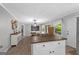 Open kitchen and dining area with center island, stainless fridge, light fixture, and back patio access at 1256 Horsley Mill Rd, Carrollton, GA 30116