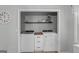 Convenient laundry room with washer, dryer, storage, and decorative wall hangings at 1256 Horsley Mill Rd, Carrollton, GA 30116