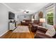 Bright living room featuring hardwood floors, comfortable furniture, and a large TV for relaxed living and entertainment at 1256 Horsley Mill Rd, Carrollton, GA 30116