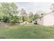 An expansive backyard view featuring the house, deck, shed, and fencing at 15 Pine Run Rd, Carrollton, GA 30116