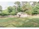Spacious backyard featuring a storage shed and a wood fence surrounding the perimeter at 15 Pine Run Rd, Carrollton, GA 30116