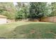 A large backyard is fully fenced in with a storage shed perfect for outdoor enjoyment at 15 Pine Run Rd, Carrollton, GA 30116