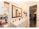 This bathroom has tile floors, a black framed mirror and white cabinetry at 15 Pine Run Rd, Carrollton, GA 30116