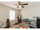 This bedroom features hardwood floors, a ceiling fan and large window at 15 Pine Run Rd, Carrollton, GA 30116