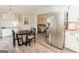 This dining area with wood floors flows into the kitchen with stainless steel appliances, creating a seamless transition at 15 Pine Run Rd, Carrollton, GA 30116