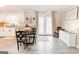 Bright kitchen and dining area features stainless appliances, light wood floors, and access to the backyard at 15 Pine Run Rd, Carrollton, GA 30116