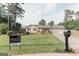 Exterior of a single-Gathering home featuring a well-manicured lawn and a Century 21 real estate sign at 15 Pine Run Rd, Carrollton, GA 30116