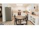 Bright kitchen with white cabinetry, modern appliances, and a cozy breakfast nook at 15 Pine Run Rd, Carrollton, GA 30116