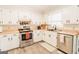 Well-lit kitchen features stainless steel appliances, white cabinets, and light countertops at 15 Pine Run Rd, Carrollton, GA 30116