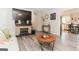 Cozy living room with a brick fireplace, mounted TV, and a view into the eat-in kitchen at 15 Pine Run Rd, Carrollton, GA 30116
