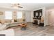 Open living room with a sectional sofa, fireplace, and ceiling fan at 15 Pine Run Rd, Carrollton, GA 30116