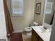 Cozy bathroom with a neutral-toned vanity and sink, alongside a toilet and decorative shower curtain at 30 Scouts Ridge Dr, Covington, GA 30016