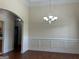Dining room featuring wainscoting, hardwood floors, and a decorative chandelier at 30 Scouts Ridge Dr, Covington, GA 30016