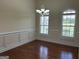 Spacious dining room with hardwood floors, wainscoting and a decorative chandelier at 30 Scouts Ridge Dr, Covington, GA 30016