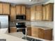 Well-equipped kitchen with wooden cabinets, stainless steel appliances, and ample countertop space at 30 Scouts Ridge Dr, Covington, GA 30016