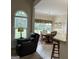 Cozy living area with a leather armchair, dining table, and large windows for ample natural light at 30 Scouts Ridge Dr, Covington, GA 30016