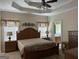 Cozy primary bedroom with a decorative ceiling and an ensuite bathroom at 30 Scouts Ridge Dr, Covington, GA 30016
