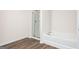 Bathroom with walk-in shower and separate soaking tub featuring wood look flooring at 251 Oliver Dr, Locust Grove, GA 30248