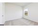 Bedroom features natural light, neutral carpet and trim, and a view from the window at 251 Oliver Dr, Locust Grove, GA 30248
