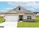 Charming single-story home with a two-car garage and well-manicured lawn at 251 Oliver Dr, Locust Grove, GA 30248