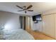 A bright bedroom features a ceiling fan, wood floors, and a mounted TV at 146 Highland Cir, Mcdonough, GA 30253
