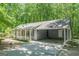 Charming single-story home with a covered carport and welcoming front porch, nestled among lush trees at 146 Highland Cir, Mcdonough, GA 30253