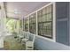 This porch is light and airy, with white chairs and a stone floor, perfect for relaxing outside at 146 Highland Cir, Mcdonough, GA 30253