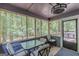 Relaxing screened porch featuring an outdoor dining table and wooded views at 146 Highland Cir, Mcdonough, GA 30253