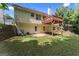 Large, grassy backyard with a deck, patio, and retaining wall, perfect for outdoor activities at 462 Chase Marion Way, Mcdonough, GA 30253