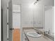 Bathroom featuring a sink with a large mirror and an open door at 462 Chase Marion Way, Mcdonough, GA 30253