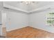 Bright bedroom with hardwood floors, a ceiling fan, and natural light from the window at 462 Chase Marion Way, Mcdonough, GA 30253