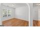 Bright bedroom with hardwood floors, wainscoting, and a large window at 462 Chase Marion Way, Mcdonough, GA 30253
