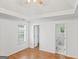 Bright bedroom with hardwood floors, a tray ceiling, and two doorways at 462 Chase Marion Way, Mcdonough, GA 30253