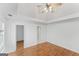 Bedroom with hardwood floors, a ceiling fan, and two doorways at 462 Chase Marion Way, Mcdonough, GA 30253