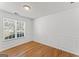 Bedroom with hardwood floors, neutral wall color, and large window at 462 Chase Marion Way, Mcdonough, GA 30253