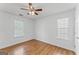 Well-lit bedroom features hardwood floors and a ceiling fan at 462 Chase Marion Way, Mcdonough, GA 30253