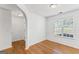 Bright bedroom with hardwood floors, wainscoting, and a large window at 462 Chase Marion Way, Mcdonough, GA 30253