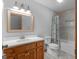 Bathroom featuring a wood vanity, granite countertop, framed mirror, and updated fixtures at 50 Ridgeview Dr, Jonesboro, GA 30236