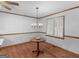 Dining room with wood floors, classic chandelier, and shuttered window at 50 Ridgeview Dr, Jonesboro, GA 30236