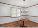 Dining room with wood floors, classic chandelier and shuttered window at 50 Ridgeview Dr, Jonesboro, GA 30236
